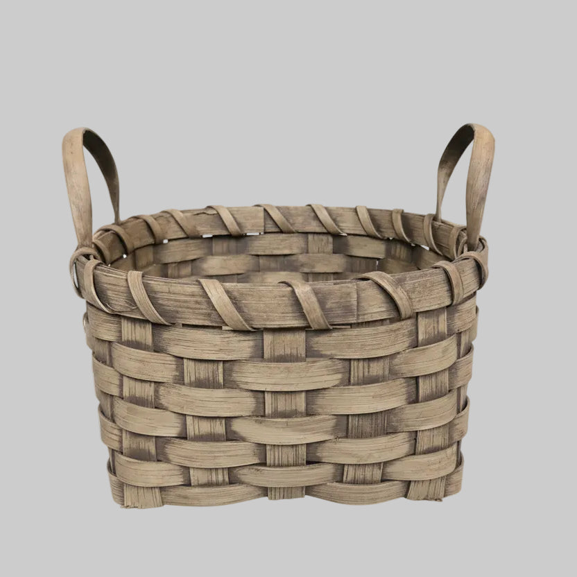 Woven basket with a handle on a textured surface