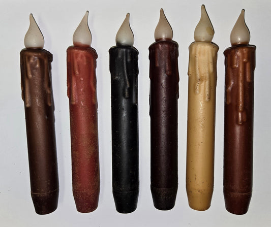 A set of LED timer taper candles in various colors including brown, red, black, burgundy, cream, and rust, each with a drip-like texture along the length.