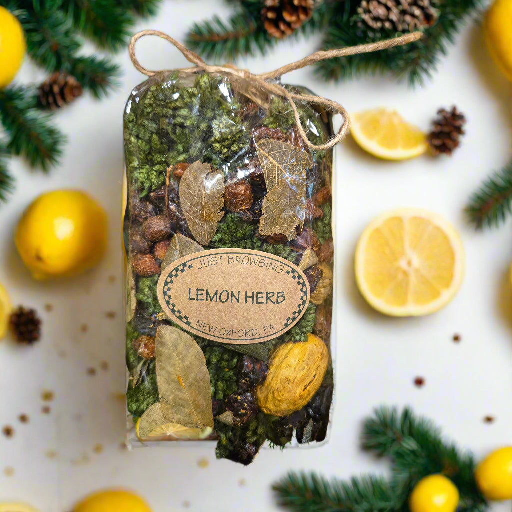 Packaged lemon herb mix with a label on a decorative background with lemons and pine branches.