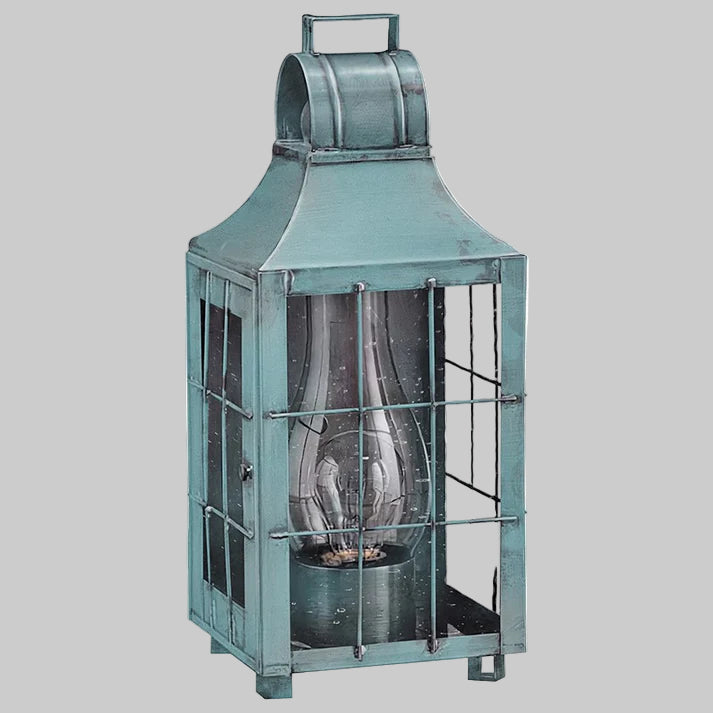 Teal metal lantern with glass panels on a white background