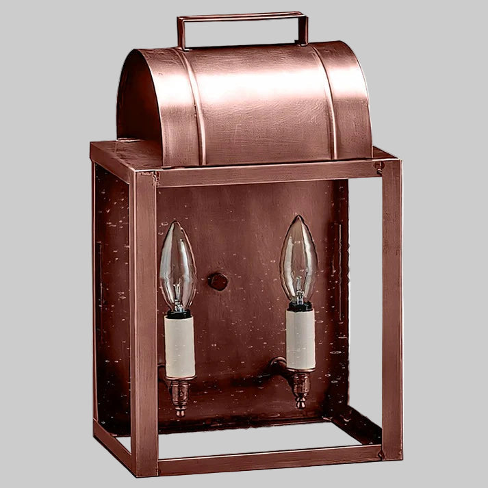 Copper outdoor wall light fixture with two clear glass bulbs on a gray background