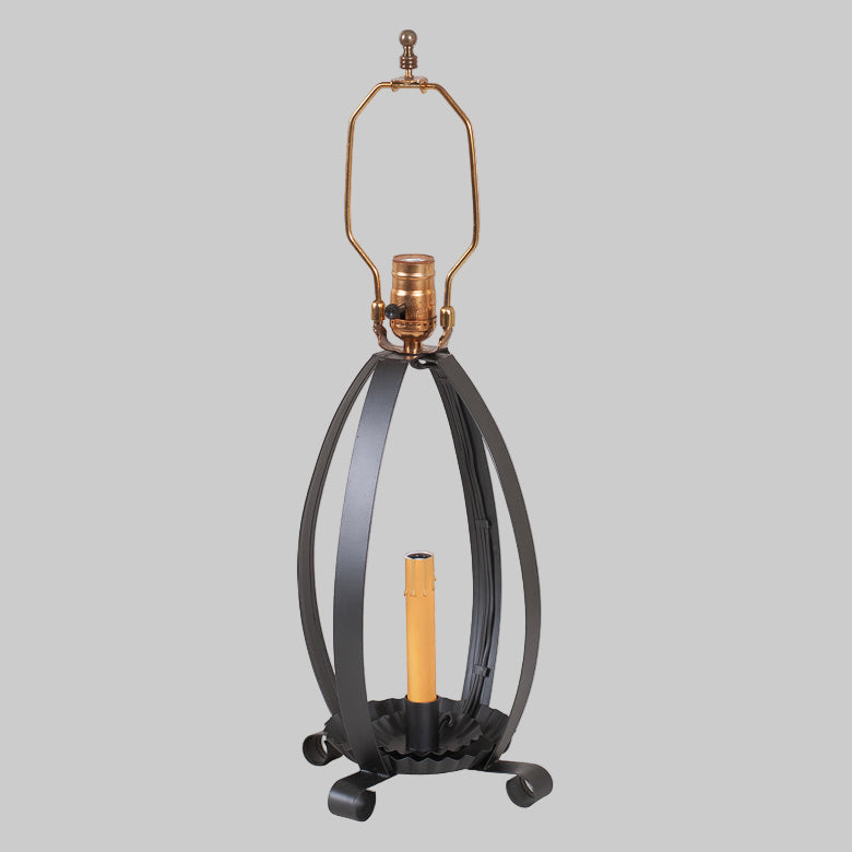 Decorative lamp with black metal base and gold accents on a white background
