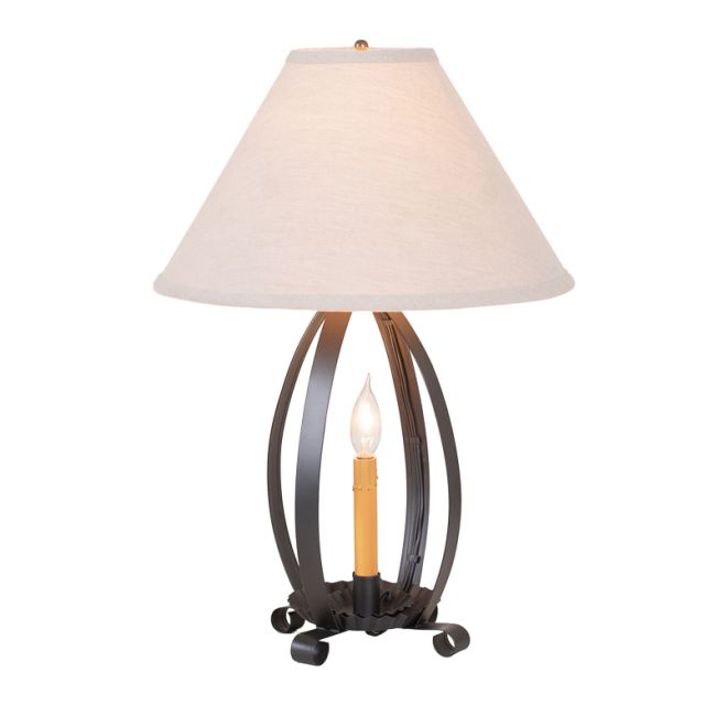 Table lamp with a decorative metal base and white shade on a white background