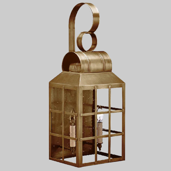 Decorative brass lantern with glass panels on a gray background