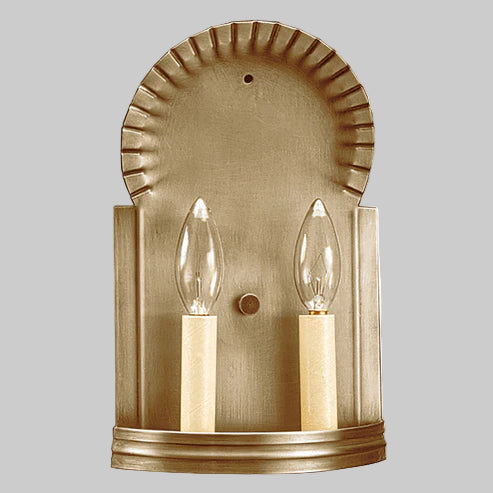 Brass wall sconce with two light bulbs on a gray background