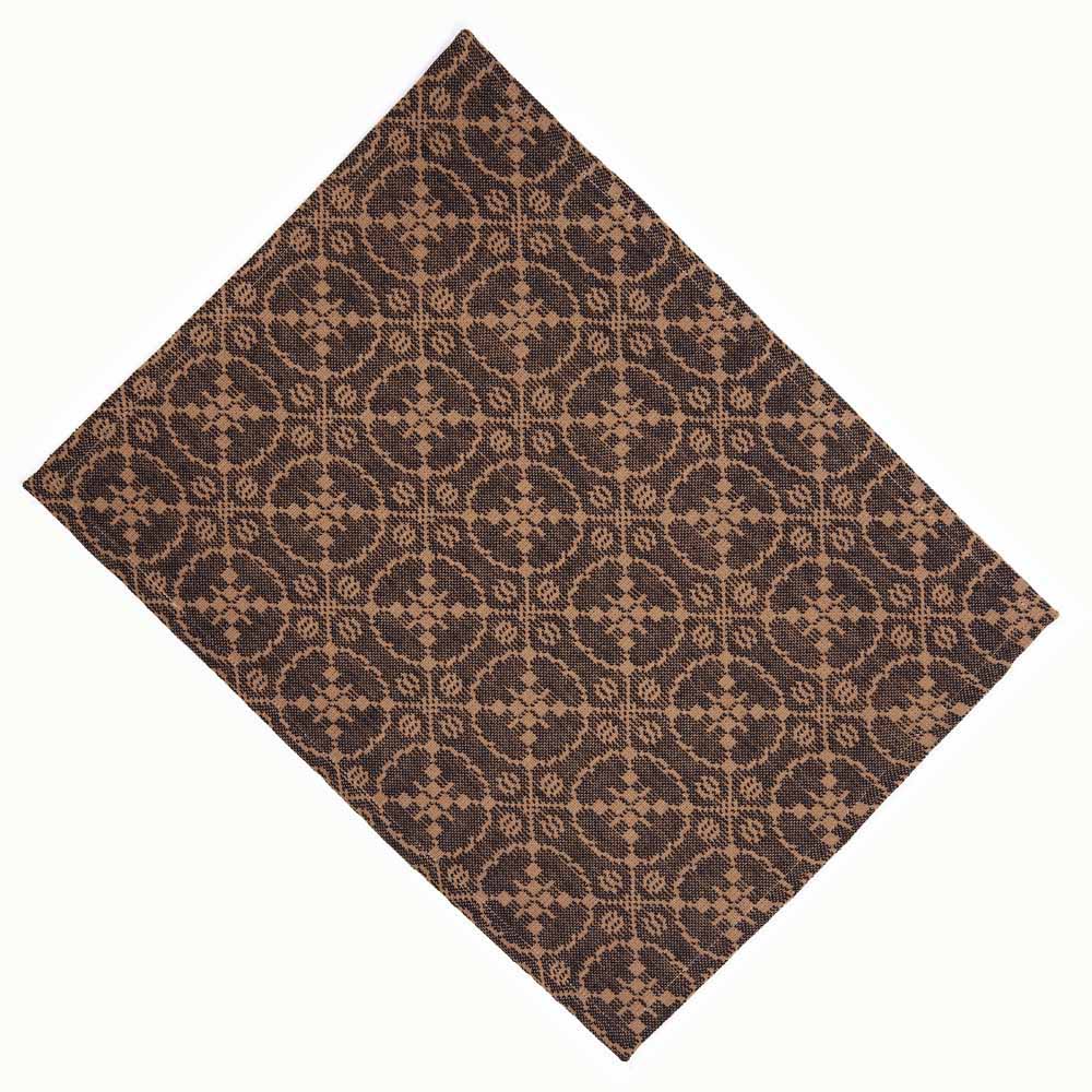 A rectangular jacquard placemat in black with an intricate geometric pattern.