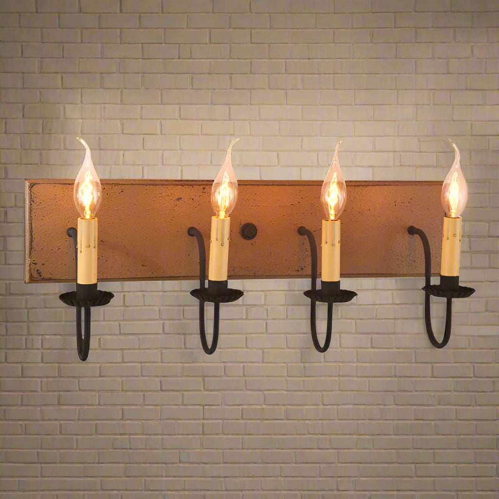 A pearwood vanity light with black textured arms and crimped pans, featuring four light bulbs.