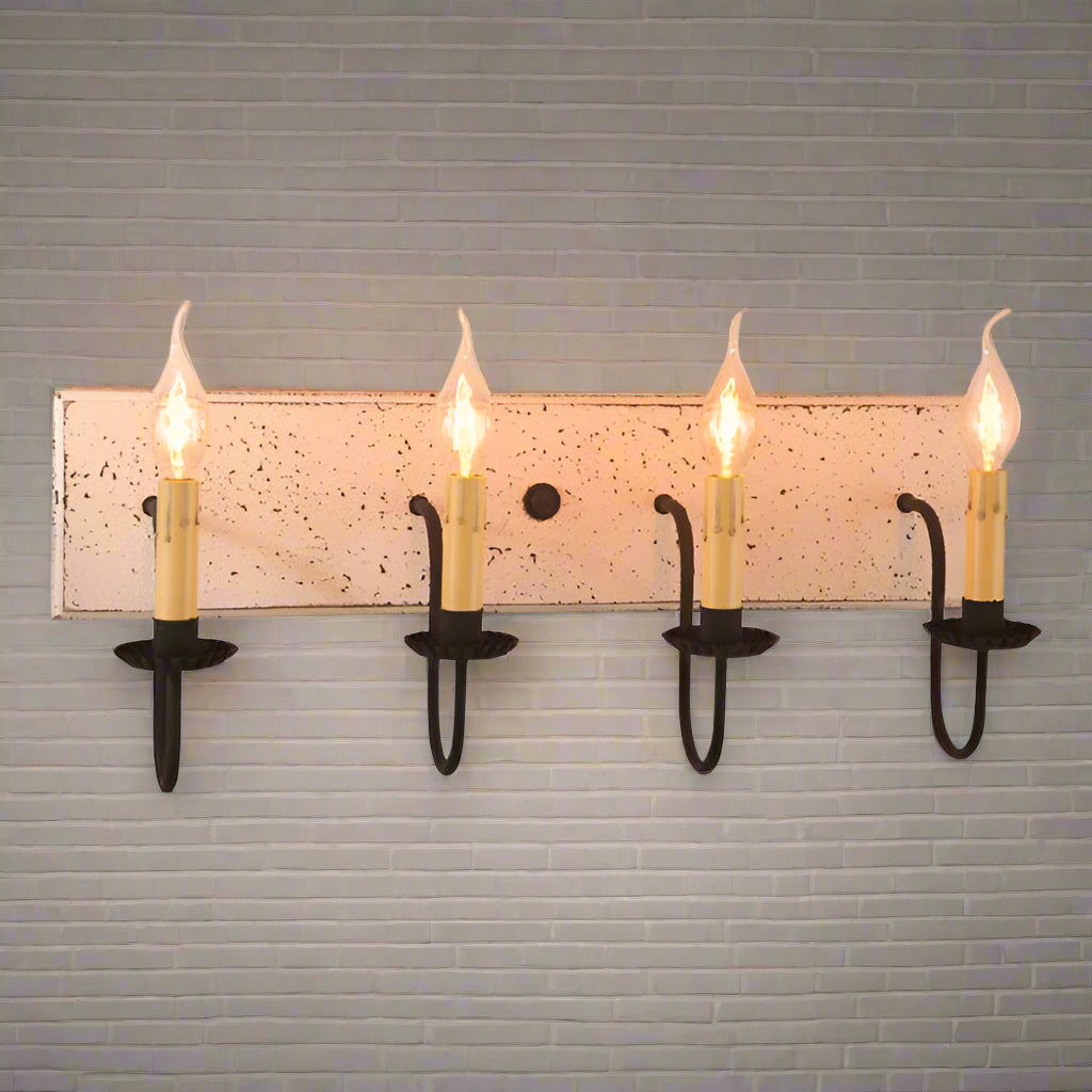 A vintage white four-light vanity light with black textured arms and crimped pans, handcrafted in Pennsylvania.