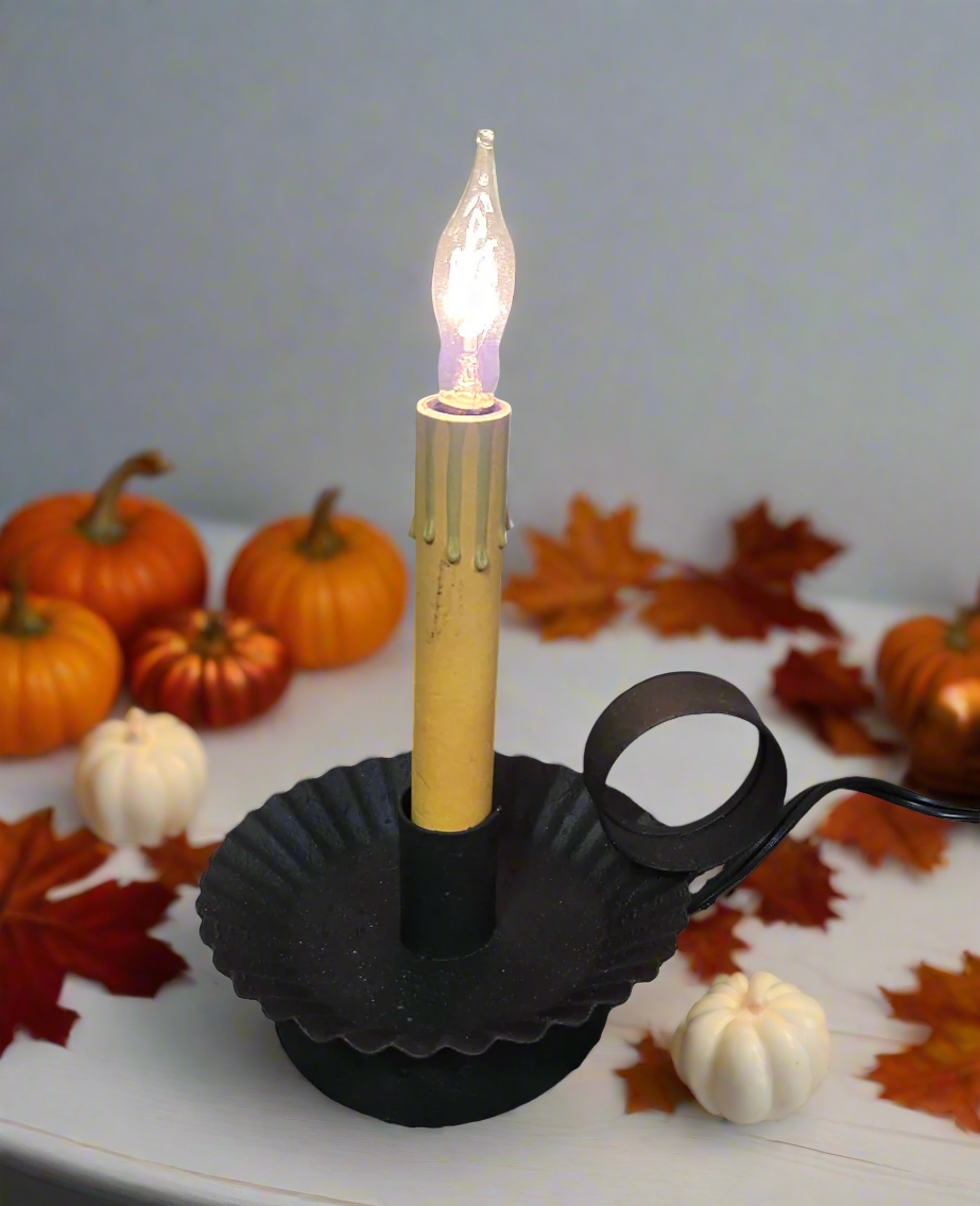 Electrified candle pan with crimped edges and a cream color sleeve and clear flame tip bulb