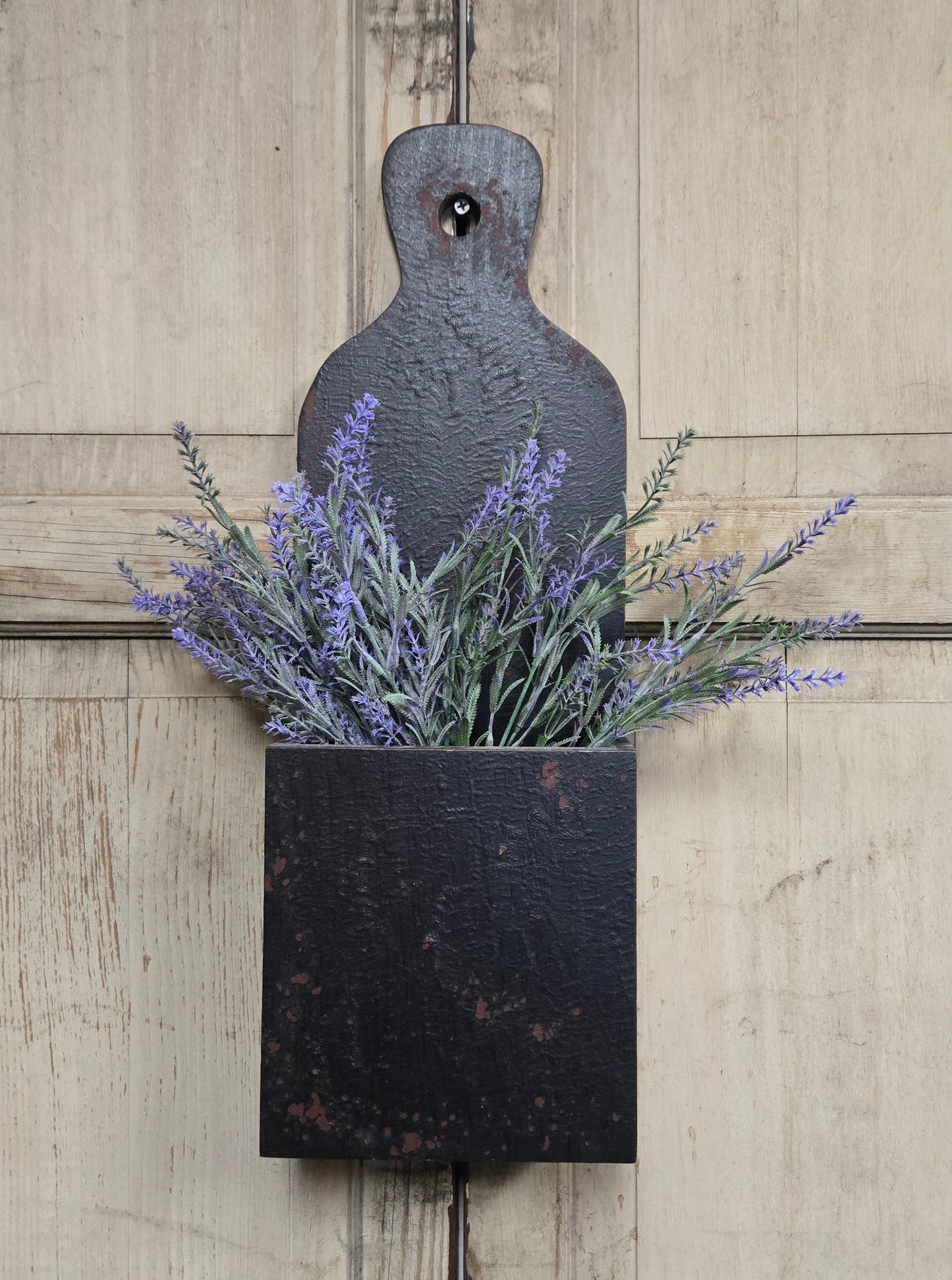 Decorative wall planter with lavender on a wooden background