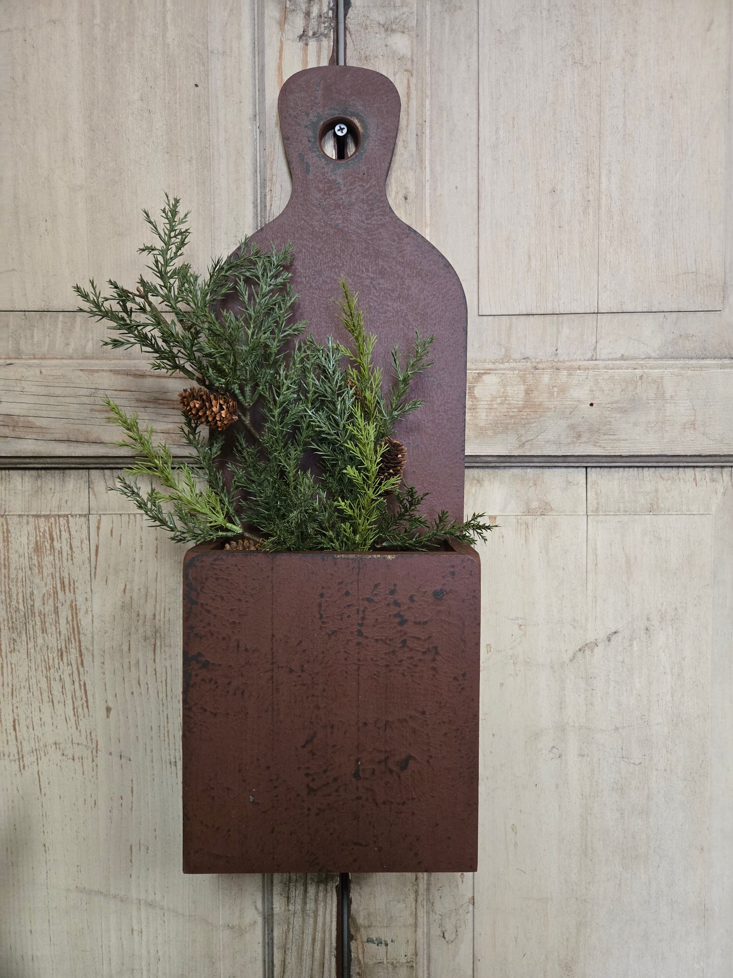Rustic wooden wall box with greenery on a light wood background