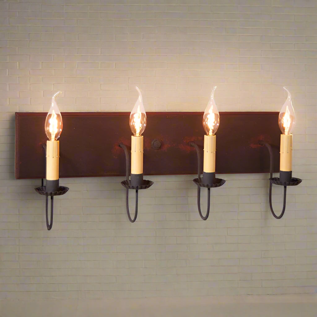 A four-light vanity light fixture with a black finish and red stripes, featuring textured arms with crimped pans and E12/Candelabra sockets.