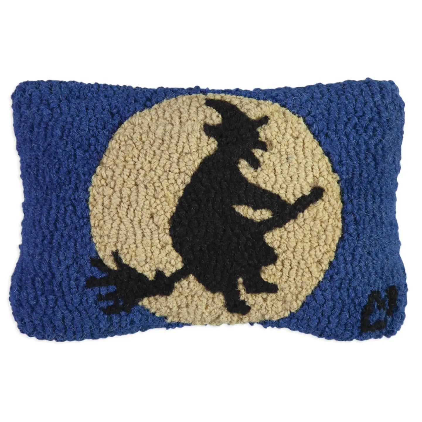 Decorative pillow with a witch on a broom design against a blue background