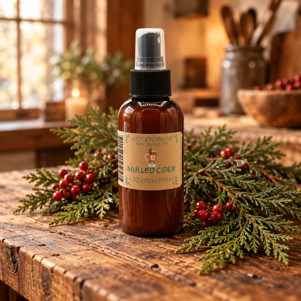 Brown spray bottle with a label on a gray background surrounded by cinnamon sticks and spices