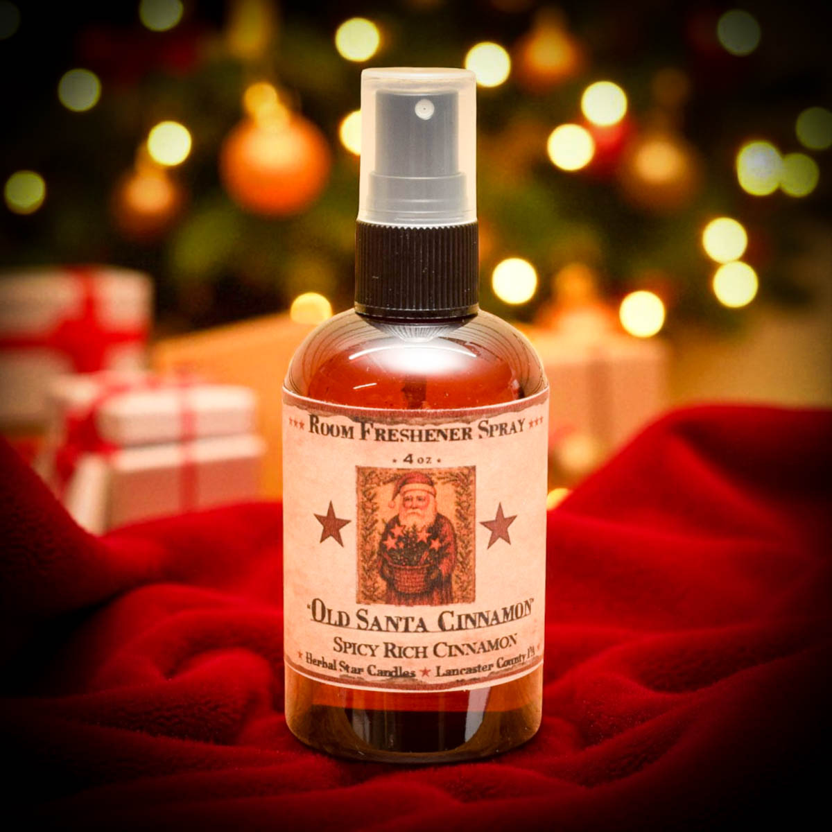 Bottle of Old Santa Cinnamon room freshener spray with a Christmas tree and presents in the background.