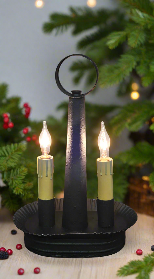 An oval double accent light with a textured black finish, featuring two candle-like lights, mounted on a solid metal structure.
