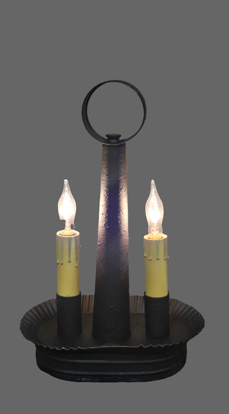 An oval double accent light with a textured black finish, featuring two candle-like lights, mounted on a solid metal structure.