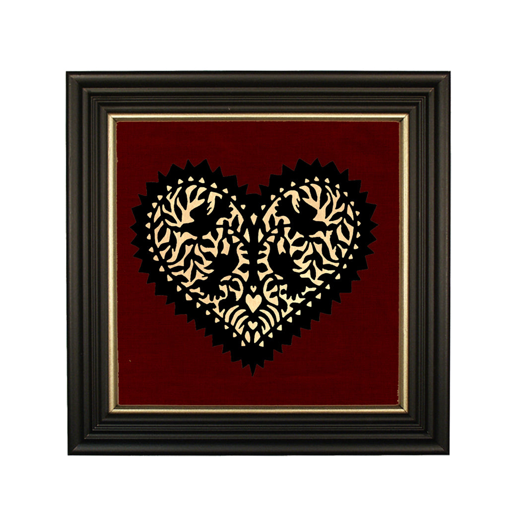 A black paper cut silhouette of four lovebirds in the shape of a heart, with a cream paper background, framed in a solid ash wood frame with gold trim.