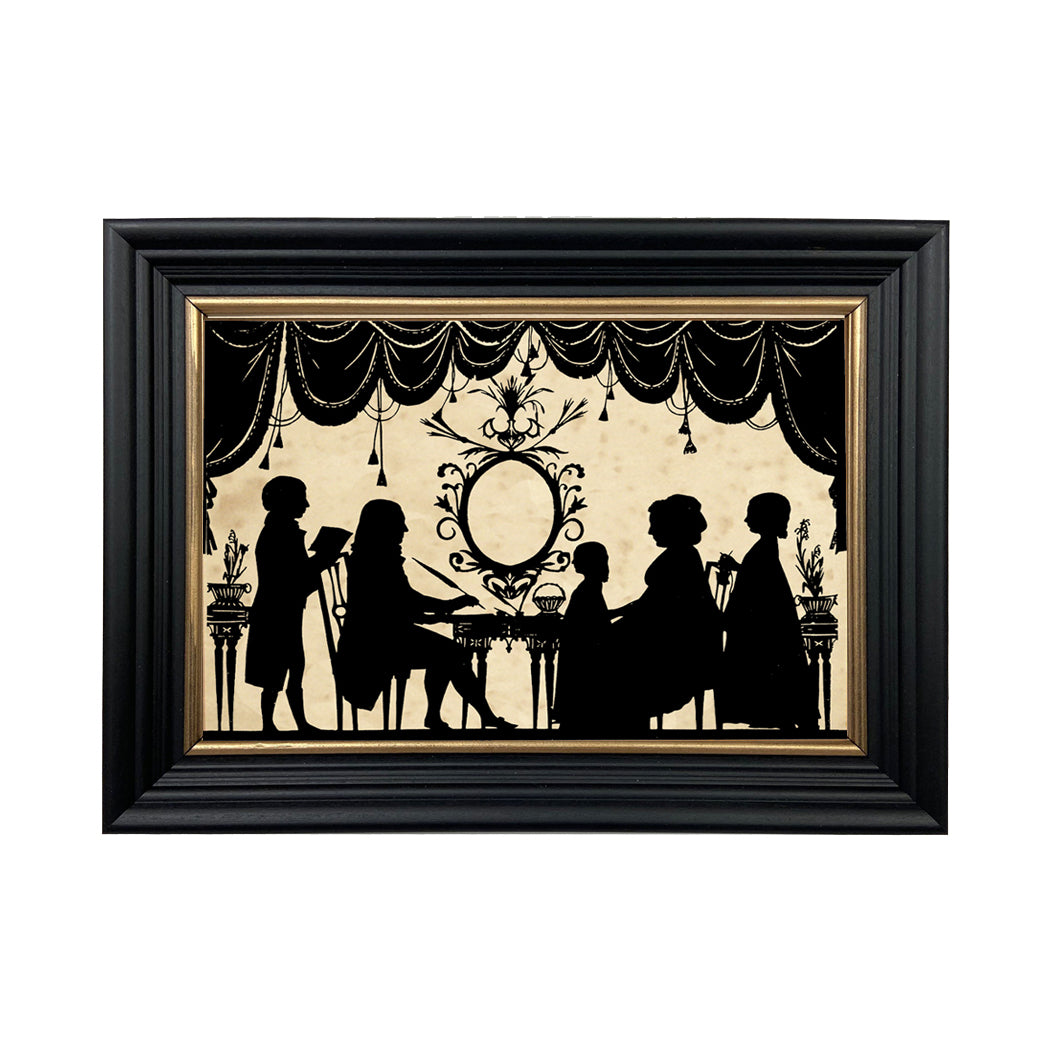 A framed paper cut silhouette artwork featuring a vintage scene with people in Victorian clothing, predominantly in black with gold accents.