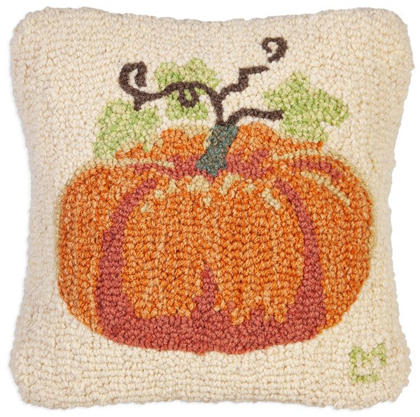 Square hooked wool pillow with an orange pumpkin design on a cream background