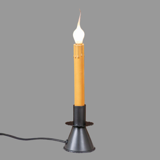 An electric window candle with a classic cone candlestick base in a smokey black finish, emitting a warm light on gray background.