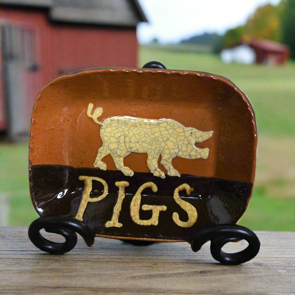 Small rectangular ceramic plate with animal motif and the word 'PIGS'