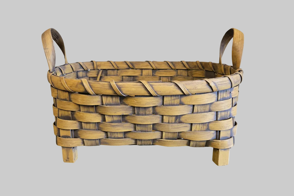 Woven basket with a handle on a wooden surface