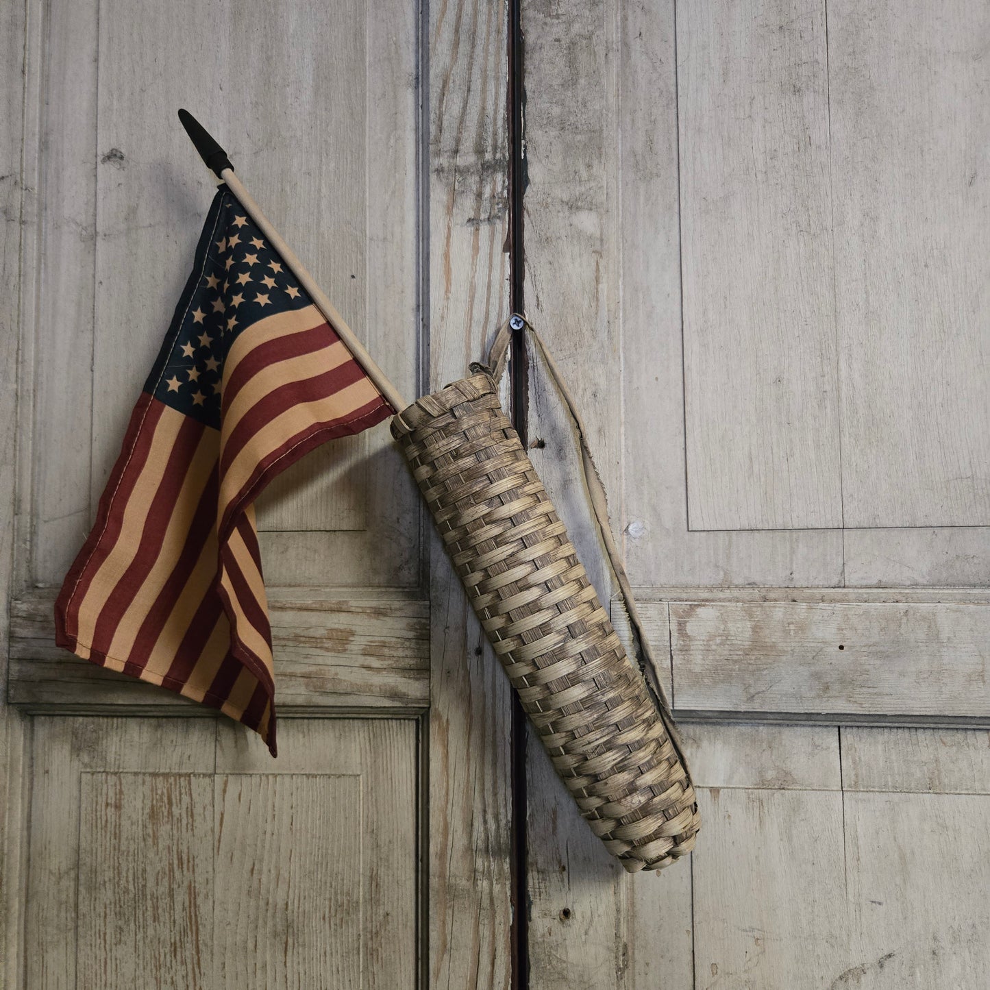 Vintage-style American flag and rifle on a wooden surface