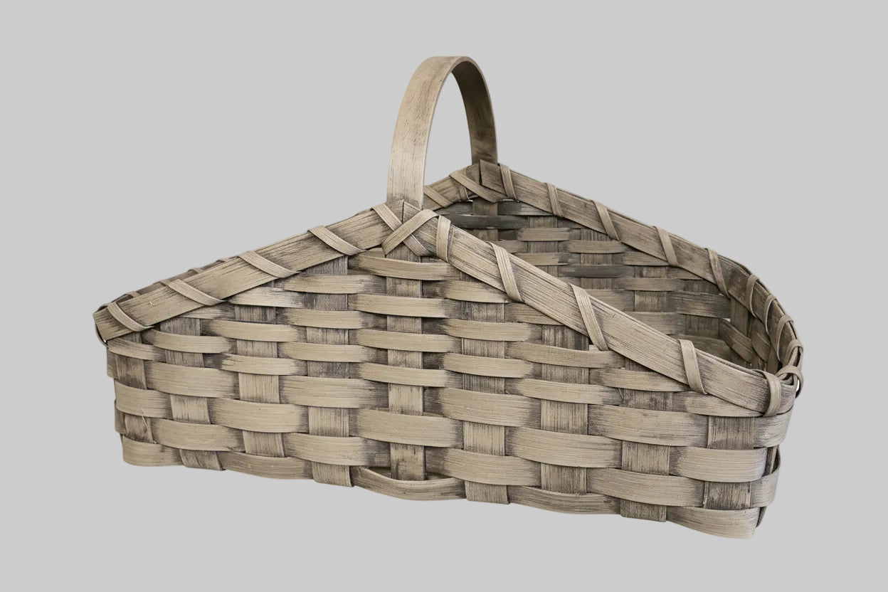 Woven basket with a handle on a wooden surface