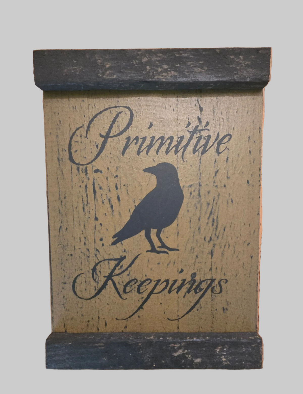 Wooden sign with 'Primitive Keepings' and a crow silhouette on a gray background