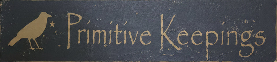 Wood sign with 'Primitive Keepings' text on a wooden background