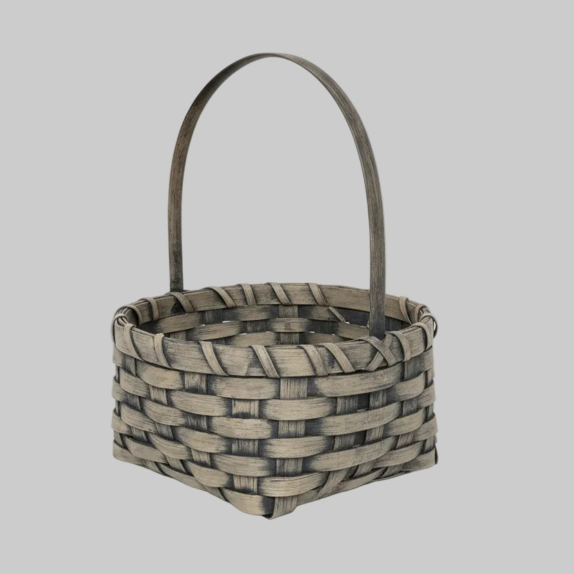 Woven basket with a handle on a wooden surface