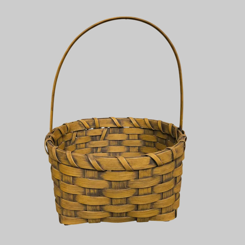 Woven basket with a handle on a wooden surface