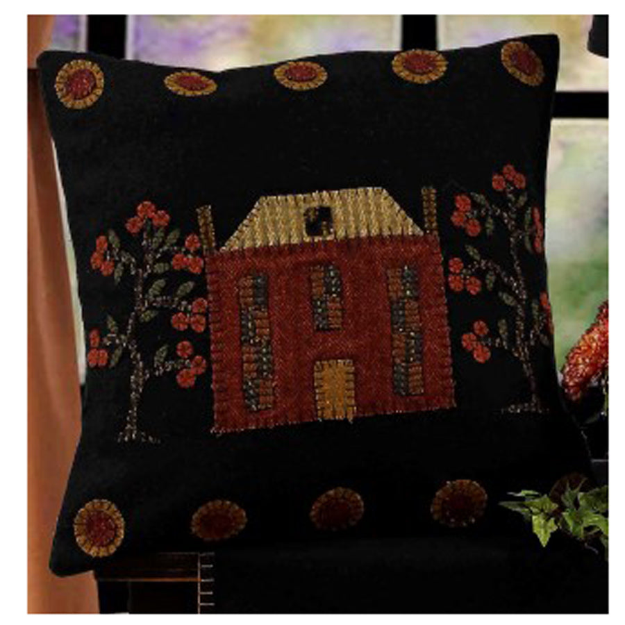 Black throw pillow with house and trees