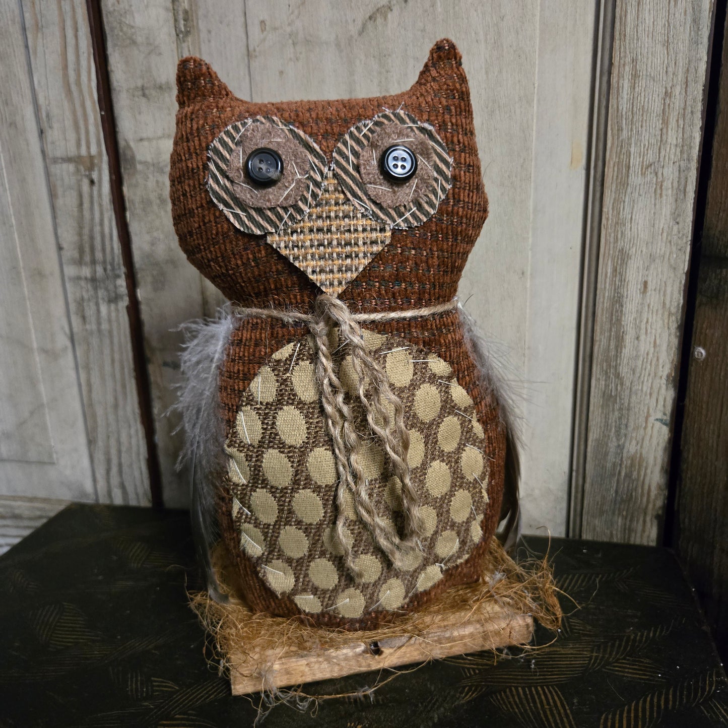 Decorative owl made of fabric with polka dot pattern on a wooden background