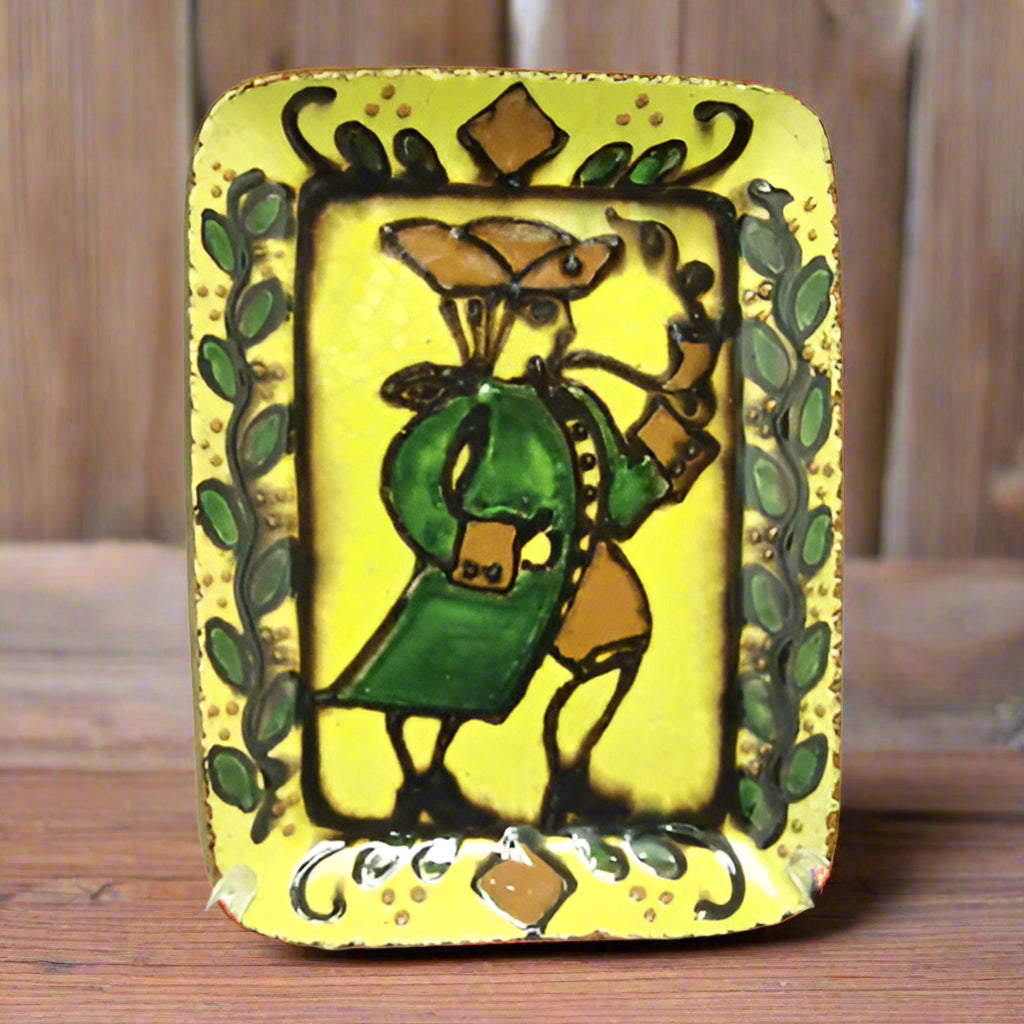 A ceramic plate featuring a redware illustration of a Colonial man with intricate detailing and leafy frame.
