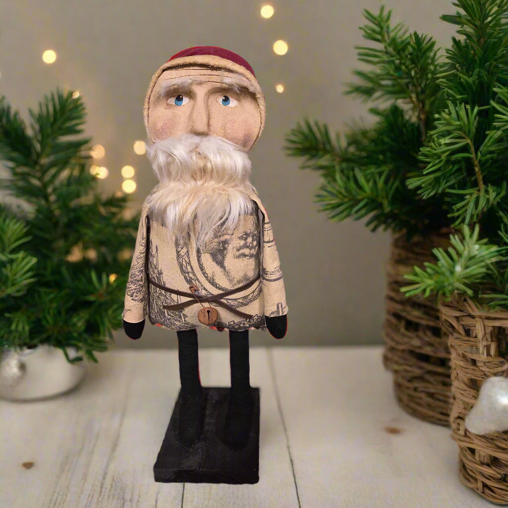 Primitive Santa on a wooden base with white door background.