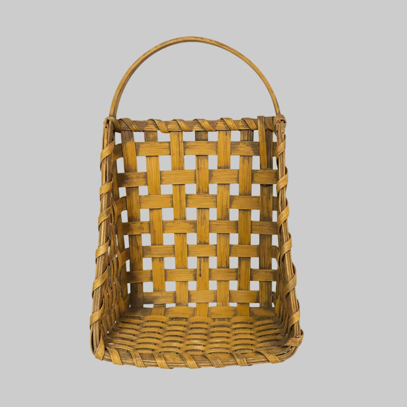Woven basket with a handle on a wooden surface