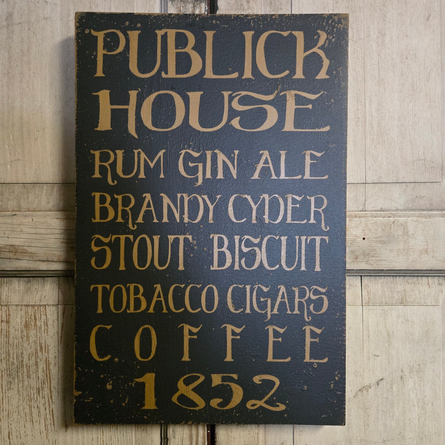 Wooden sign with text listing items and years on a wooden surface