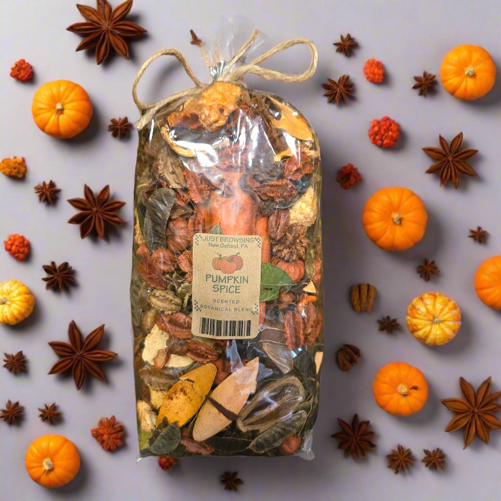 Packaged pumpkin spice mix with a label on a decorative background of green leaves.