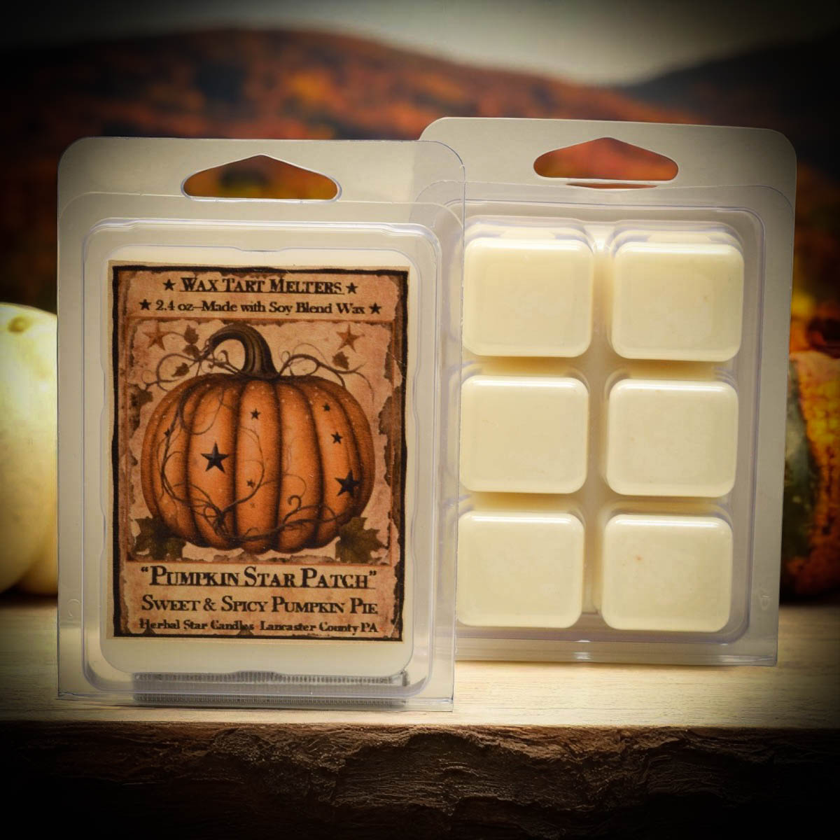 Pumpkin-themed wax tart melt packaging with a warm glow.