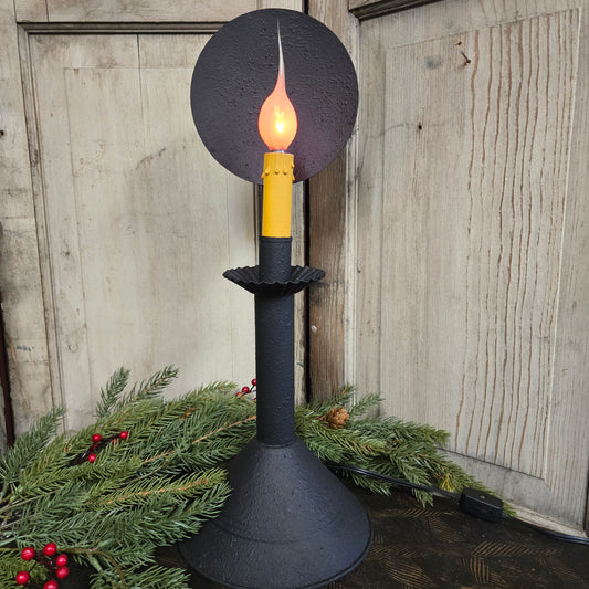 Decorative accent light with a flame design on a wooden surface.