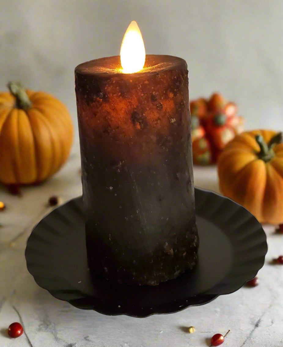 Realistic black moving flame mini pillar in black wax on a timer.