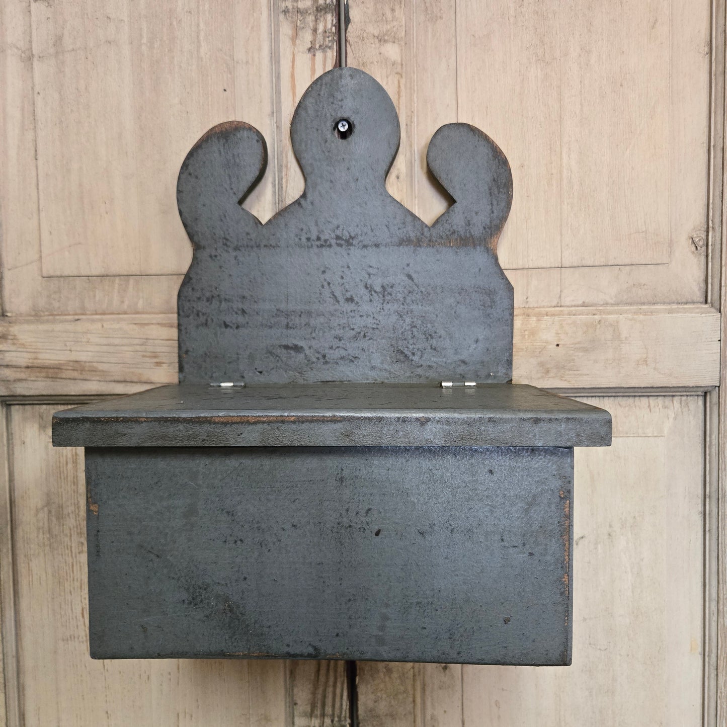 Wooden box with hinged lid on cream background