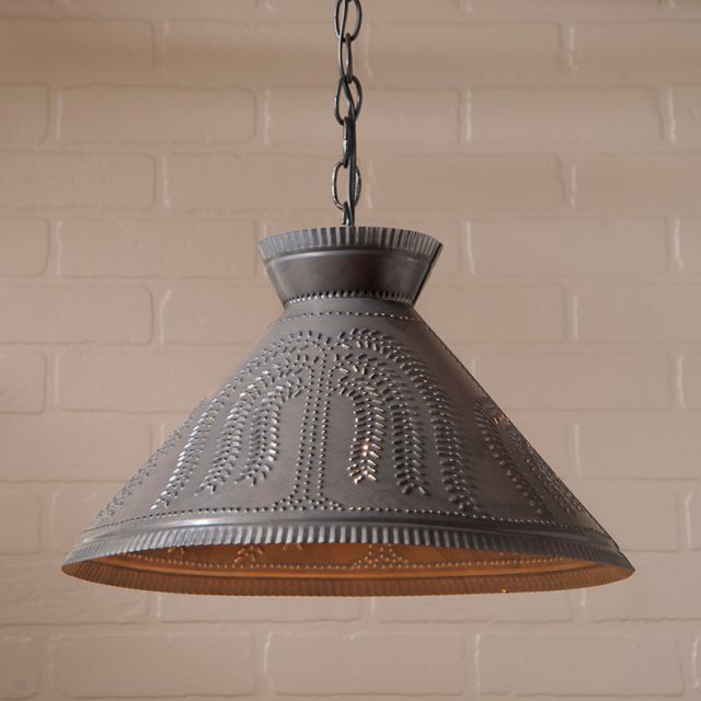 Decorative pendant light with willow tree design against a brick wall background