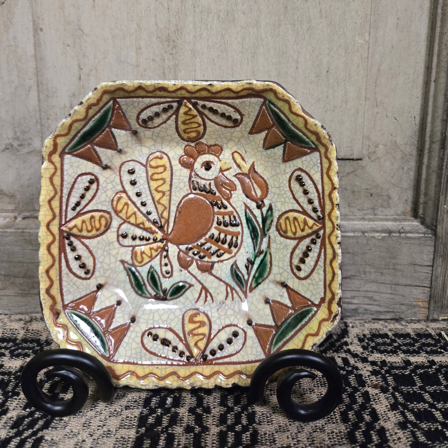 Octagonal redware plate with rooster and flower motif