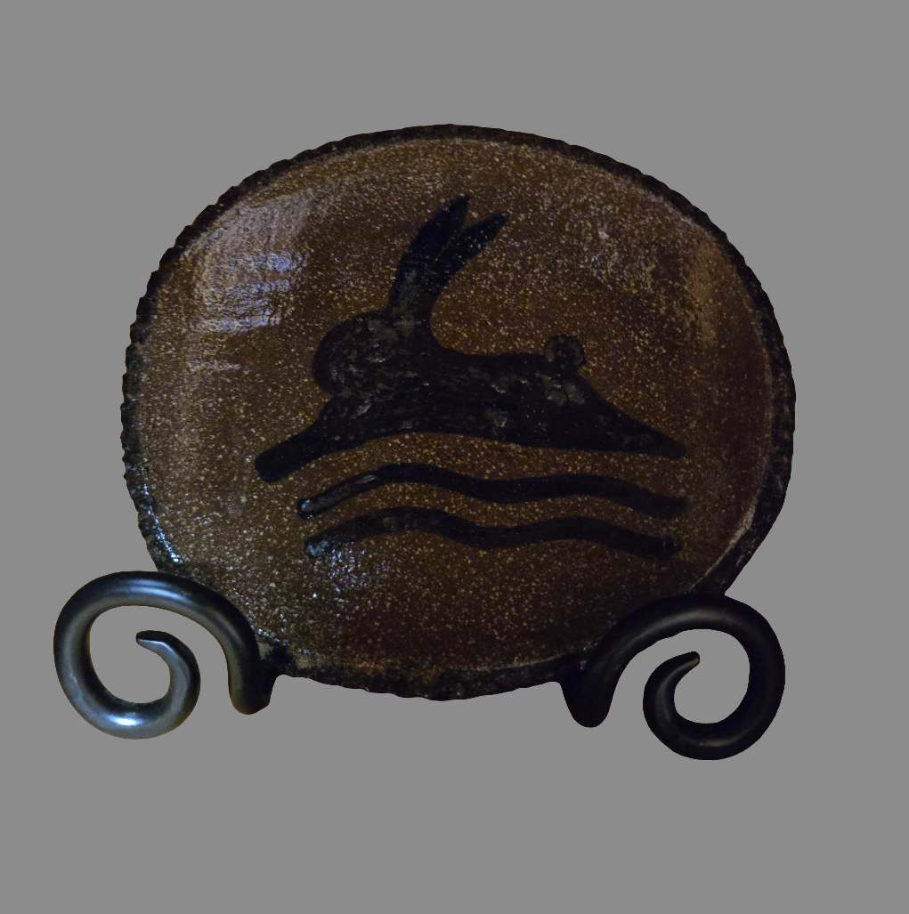 Small oval stoneware plate with running bunny and squiggle design