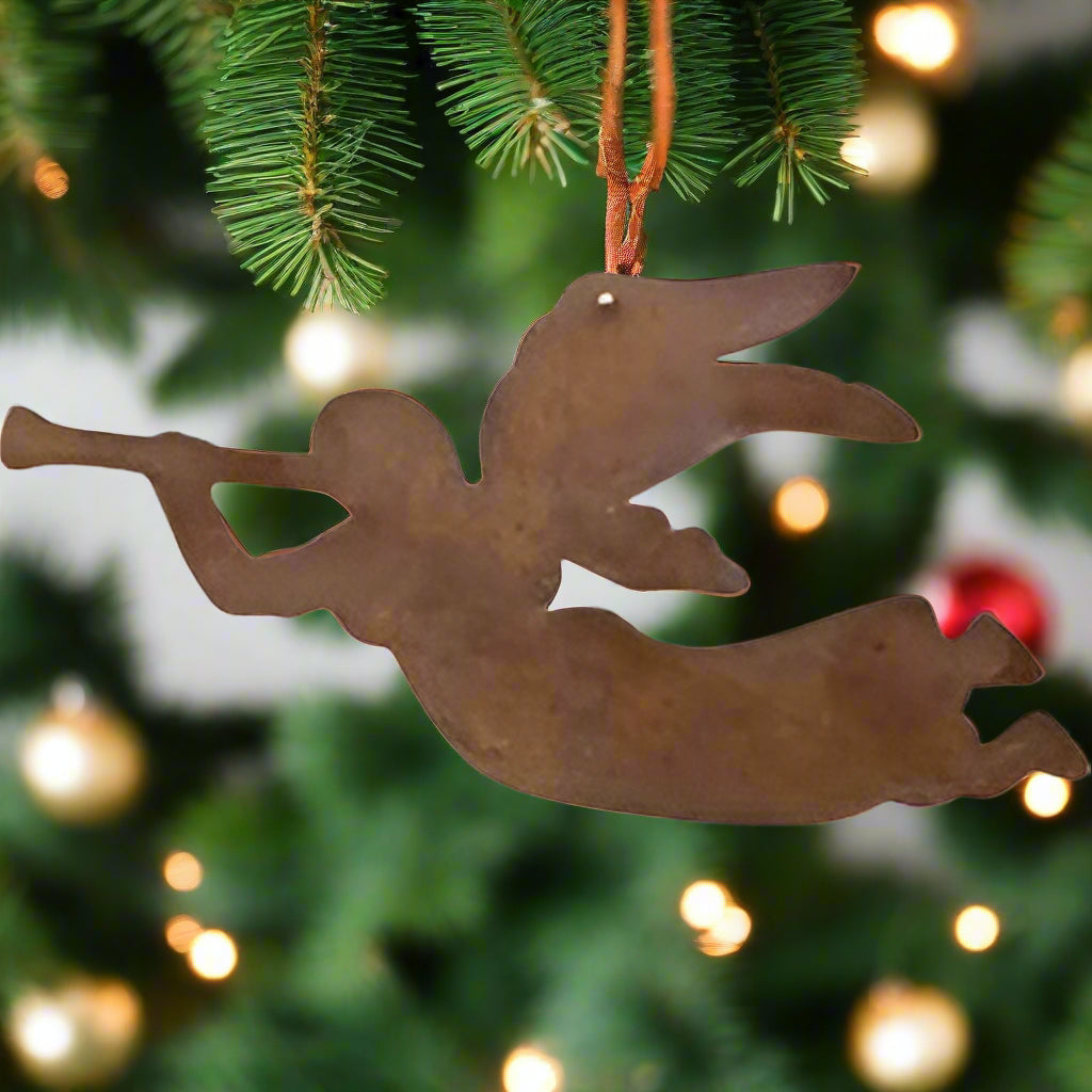 Rusty flying angel ornament on white background