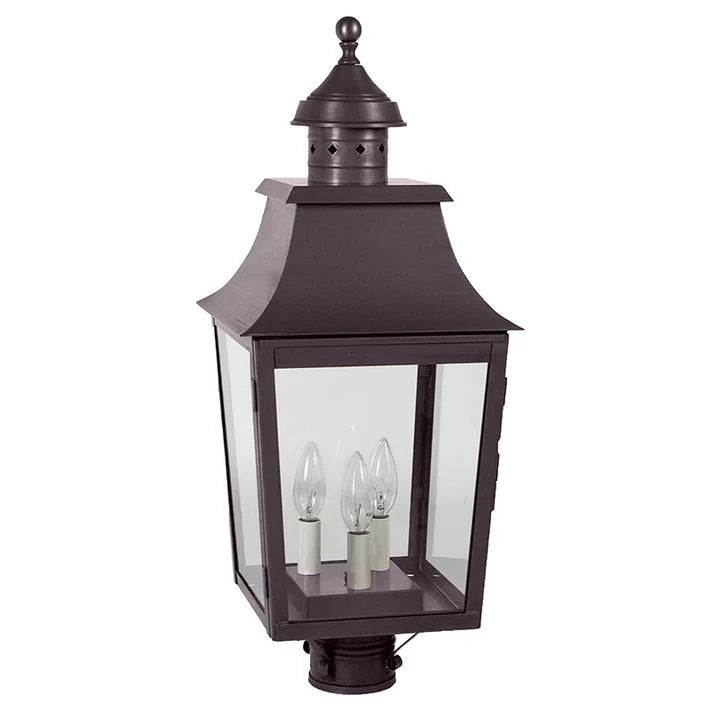 Decorative outdoor lamp with clear glass panels on a white background