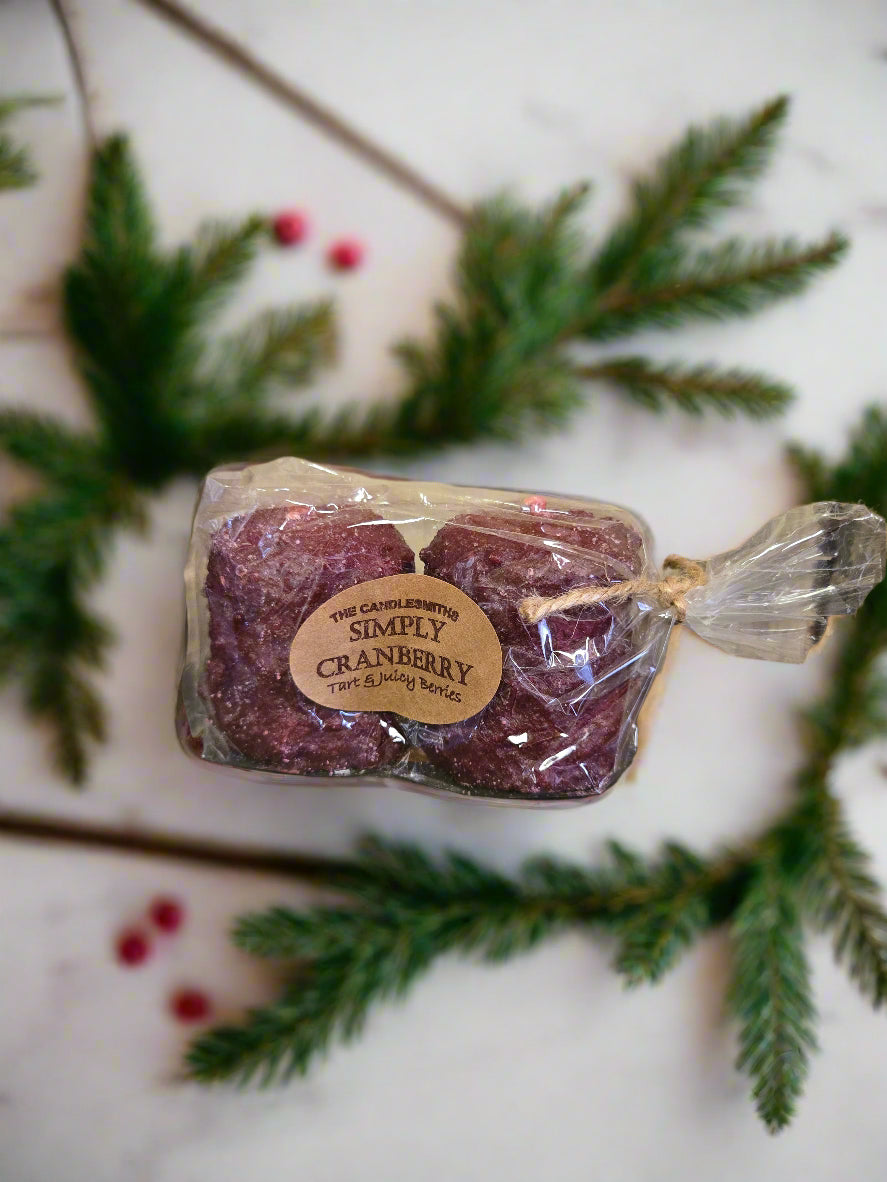Two red cranberry votive candles packaged together with a label showing the brand and product name.